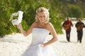 Gorgerous bride walking to wedding ceremony on the beach with bo Royalty Free Stock Photo
