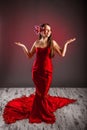 Gorgeus Girl in a Red Dress with flower in hair Royalty Free Stock Photo