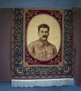 Gori Georgia - Oriental rug  with Joseph Stalins portrait hangs in town of his birthplace with blue rug on wall and Royalty Free Stock Photo