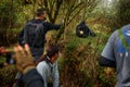 Gorilla - wildlife photographers. Mountain gorilla, Mgahinga National Park in Uganda. People on the tour, man with camera and cell Royalty Free Stock Photo