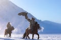 Golden eagle during the winter Mongolia local men riding on horses around the mountains covered with snow Royalty Free Stock Photo