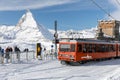 Red cable car train on snowy railway at Gornergrat, Zermatt