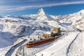 Red cable car train on snowy railway at Gornergrat, Zermatt Royalty Free Stock Photo