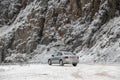 Light gray Volkswagen Polo car against frozen rock on the background Royalty Free Stock Photo