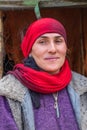 A woman wearing a red head scarf in the mountains of Tajikistan