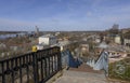 GORODETS, RUSSIA - APRIL 17, 2023: Iron staircase leading to the street, river and port with cranes