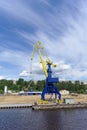 Gorodets, Russia. - June 2.2016. Blue portal crane with a yellow arrow on the cargo wharf in Gorodets about Gateway.