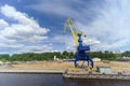 Gorodets, Russia. - June 2.2016. Blue portal crane with a yellow arrow on the cargo wharf in Gorodets about Gateway.