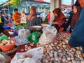 Gorontalo,Indonesia-November 14,2023 : the garlic seller is serving customers