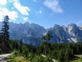 Gosau - Gravelled road in the mountains with the view on high Alps in the region of Gosau, Austria. Royalty Free Stock Photo