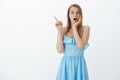 Gosh is it spider on ceiling. Portrait of shocked and stunned good-looking stylish woman in blue dress dropping jaw