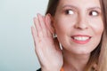 Gossip girl eavesdropping with hand to ear. Royalty Free Stock Photo