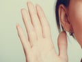 Gossip human eavesdropping with hand to ear. Royalty Free Stock Photo