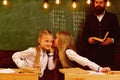 Gossip whispering, little girls whispering gossip at school lesson. gossip whispering of two girls friends. gossip Royalty Free Stock Photo