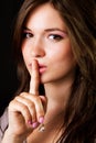 Gossip - woman with finger over lips Royalty Free Stock Photo