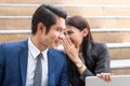 Gossip in the workplace. Business Woman whispering to colleague during work together. Man face is surprised about rumour Royalty Free Stock Photo