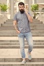 Got it. Business conversation. Man with smartphone. Stylish handsome man with bristle outdoors. Man wearing casual shirt Royalty Free Stock Photo