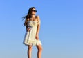 She got great style. Happy young woman posing over blue sky. pretty young beautiful woman in sunglasses. Summer outfit Royalty Free Stock Photo