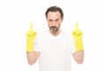 Got an idea. He will cope with any task. mature man wear rubber gloves. man cleaning home. care your hands while washing