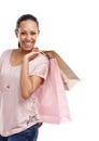Got some great deals today. Portrait of an attractive young woman holding shopping bags over her shoulder isolated on