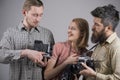 He got some great shots. Retro style woman and men hold analog photo cameras. Group of photographers with retro cameras Royalty Free Stock Photo