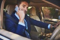 Got to get to work quickly. a confident young businessman talking on his cellphone while driving his car.