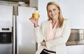 Got to keep those vitamin levels high. Portrait of a cheerful middle aged businesswoman enjoying a glass of orange juice Royalty Free Stock Photo