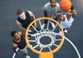 Got to practice your hoops everyday. High angle shot of a group of sporty young men playing basketball on a sports court Royalty Free Stock Photo