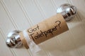 `Got Toilet Paper`, written in sharpie on cardboard toilet paper roll that is left hanging on the spool, on the wall