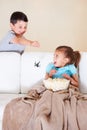 Gotcha. Mischievous young boy scaring his little sister at Halloween with a rubber spider. Royalty Free Stock Photo