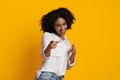 Gotcha. Positive african american woman pointing her index fingers at camera Royalty Free Stock Photo