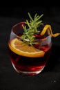 Gotfather cocktail with bourbon whiskey, amaretto, orange wedge and rosemary Royalty Free Stock Photo