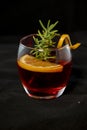 Gotfather cocktail with bourbon whiskey, amaretto, orange wedge and rosemary Royalty Free Stock Photo