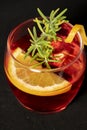 Gotfather cocktail with bourbon whiskey, amaretto, orange wedge and rosemary Royalty Free Stock Photo