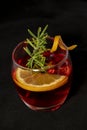 Gotfather cocktail with bourbon whiskey, amaretto, orange wedge and rosemary Royalty Free Stock Photo