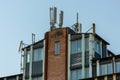 Rooftop of an office building with many mobile communications antennae..