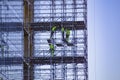 Gothenburg - Sweden. Circa Mars, 2020: Builders on working on scaffolding next to a new building in central city.