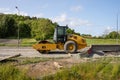 Side view of a Caterpillar CS66B vibratory soil compactor..