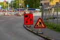 Signs warning for one lane closed at road works..