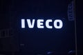 Blue glowing Iveco sign on a warehouse..