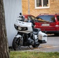 White Indian Challenger motorcycle parked by a blue shed..