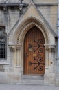 Gothic architecture building facade with ogival arched wooden door, Oxford, United Kingdom