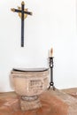 Gothic Baptismal Font with writings in Santa Clara Church. Royalty Free Stock Photo