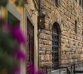 Gothic buildings and flowers on an old street in Centro Storico, Florence, Italy