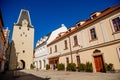 Gothic clock tower Mikulov Gate, Narrow picturesque street with colorful renaissance and baroque buildings in historic center in Royalty Free Stock Photo