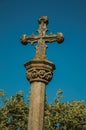 Gothic cross carved in stone on top of a pillory