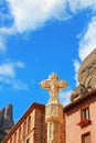 Gothic cross XV century and hotels for pilgrims, Montserrat, Spain. Area is at altitude of 706 m above sea