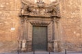 Gothic door with a bas relief and decorative ornament. Middle age church in Valencia Royalty Free Stock Photo