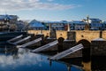 Gothic medieval Stony Deer bridge with show Riverbank of the Otava river in winter sunny day the oldest bridge in historical