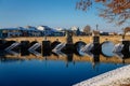 Gothic medieval Stony Deer bridge with show Riverbank of the Otava river in winter sunny day the oldest bridge in historical